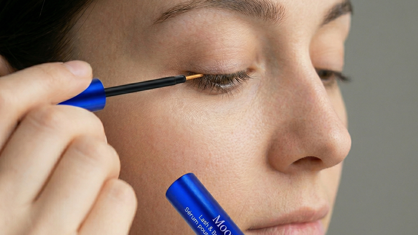 Applying a prostaglandin-free lash serum as part of a nightly lash care routine.